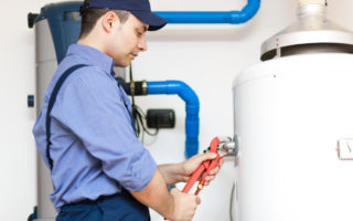 Employee repairing a hot water heater
