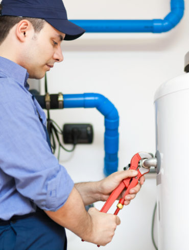 Employee repairing a hot water heater
