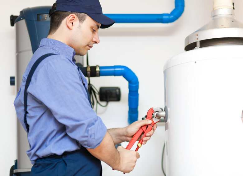 Employee repairing a hot water heater