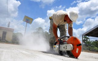 worker using a concrete hand saw
