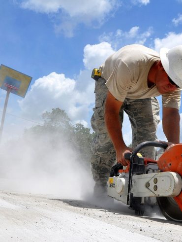 worker using a concrete hand saw