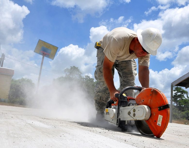 worker using a concrete hand saw