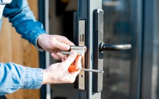 man changing core of a door lock picture id1138823660