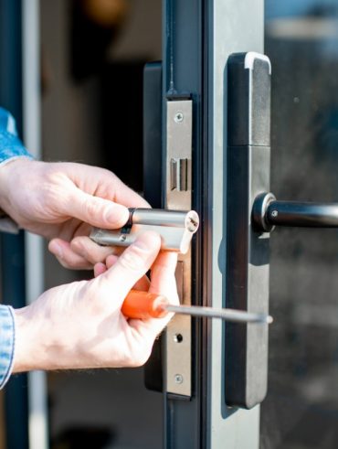 man changing core of a door lock picture id1138823660
