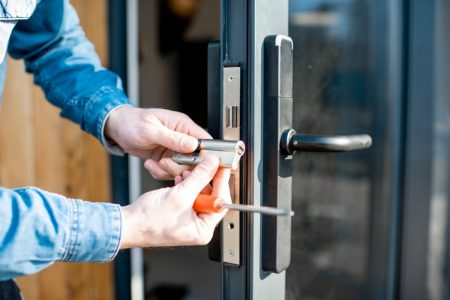 man changing core of a door lock picture id1138823660