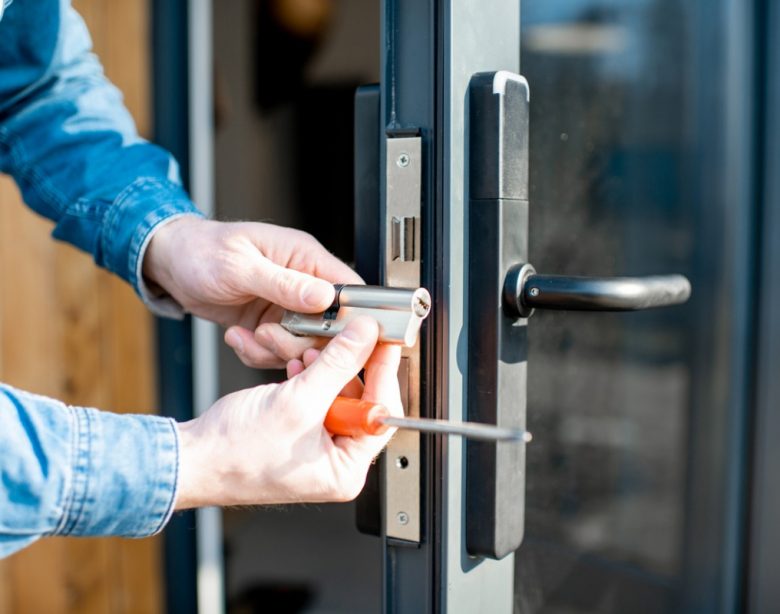 man changing core of a door lock picture id1138823660