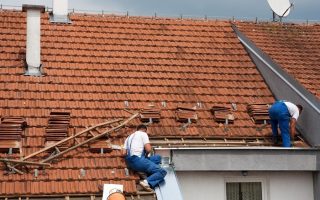 roofers working on a roof restoration 998x562 1