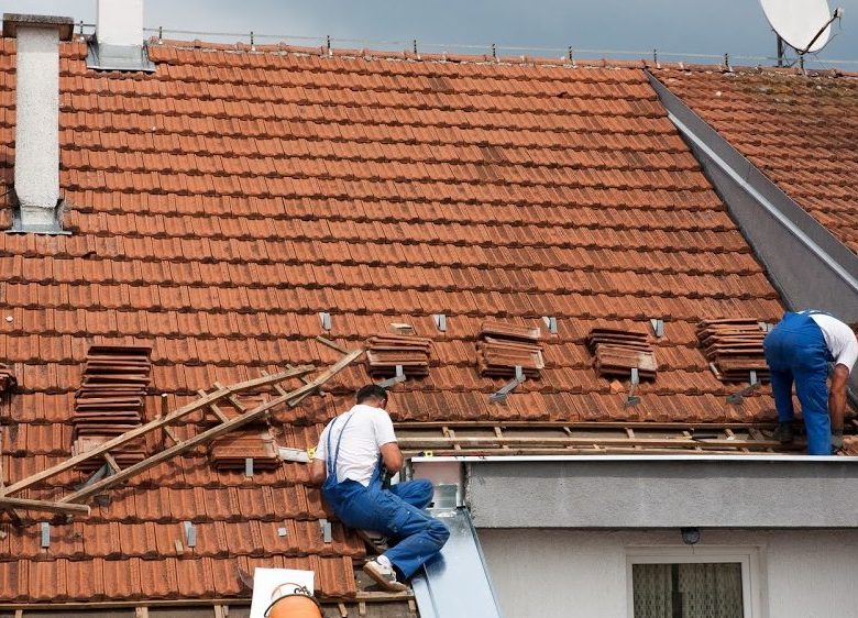 roofers working on a roof restoration 998x562 1