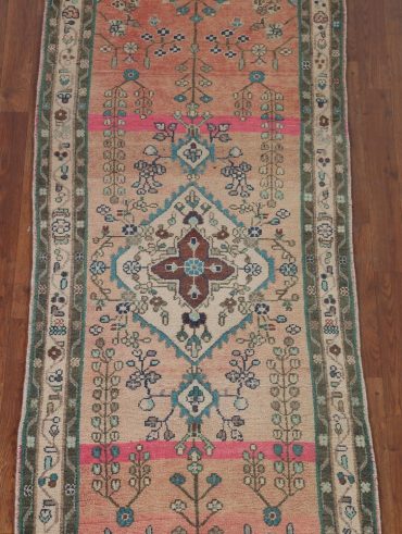 Colorful area rug defining a seating area in a living room.