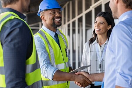 bigstock Smiling engineer shaking hands 353866670 1110x550 1