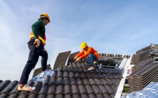2 construction workers install new roof construction site electric drill used new roofs with concrete roof tiles concept residential building construction