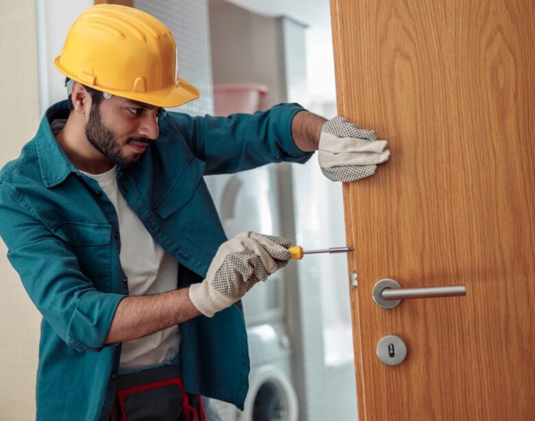 locksmith workman in uniform installing door knob 2023 01 05 00 20 11 utc